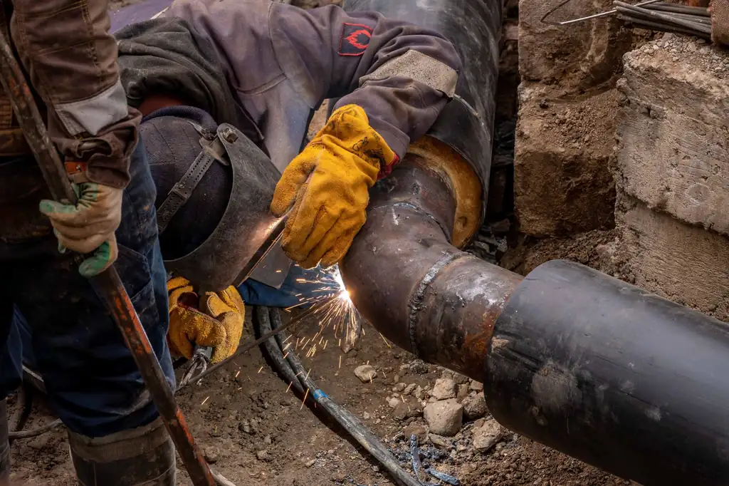 Welder joining a replacement sewer pipe